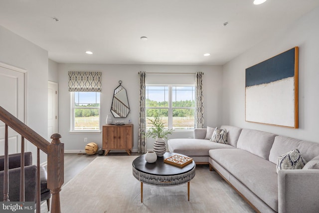living room with wood finished floors, recessed lighting, stairs, and baseboards