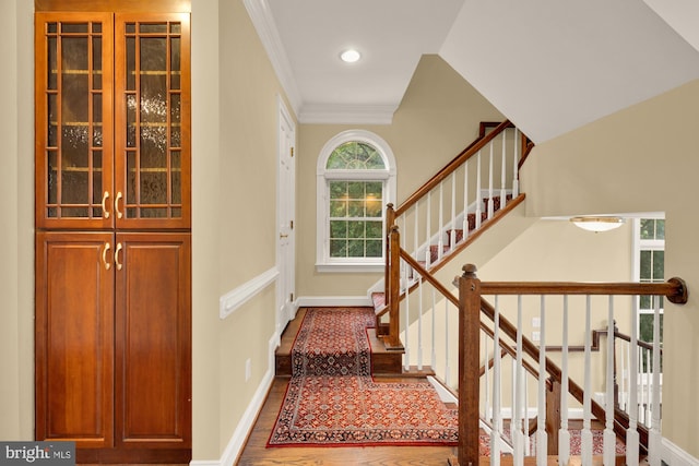 2221 N Oak Ct, Arlington, VA 22209 - stairs featuring ornamental molding, baseboards, and wood finished floors