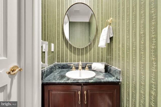 2221 N Oak Ct, Arlington, VA 22209 - bathroom with wallpapered walls, vanity, and crown molding