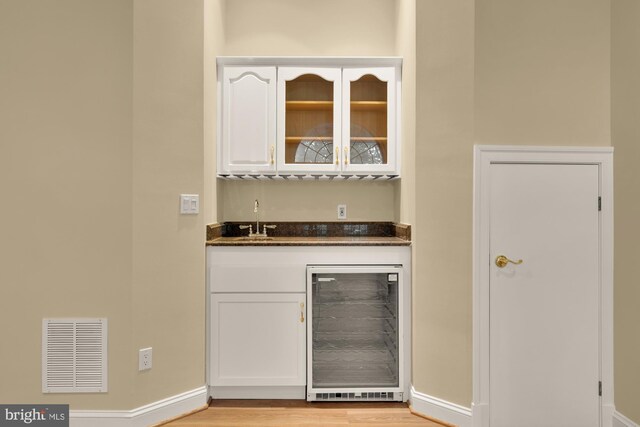 2221 N Oak Ct, Arlington, VA 22209 - indoor dry bar with wine cooler, baseboards, and light wood-type flooring