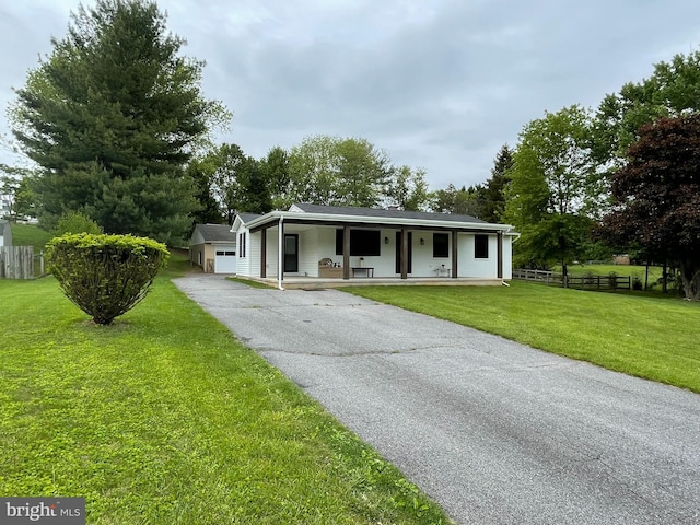 single story home with covered porch, driveway, and an attached garage