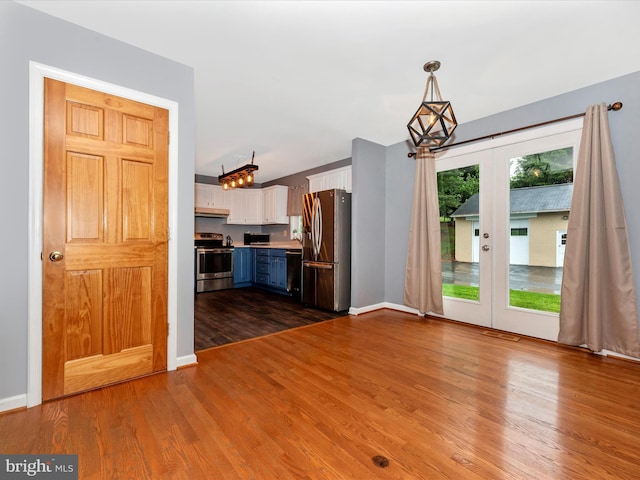 4106 Teklen Dr, Westminster, MD 21157 - unfurnished living room with french doors, dark wood-style flooring, and baseboards