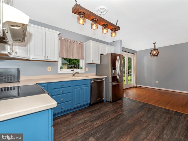 4106 Teklen Dr, Westminster, MD 21157 - kitchen featuring appliances with stainless steel finishes, extractor fan, blue cabinetry, dark wood-style floors, and white cabinets