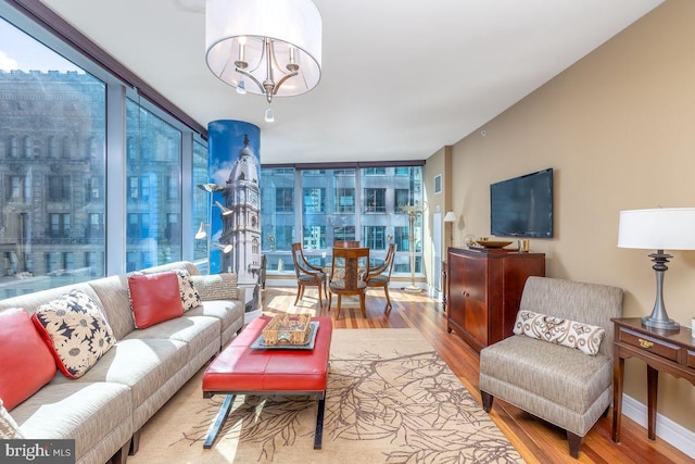 1414 S Penn Sq Unit 18H, Philadelphia, PA 19102 - living area featuring wood finished floors and a wall of windows
