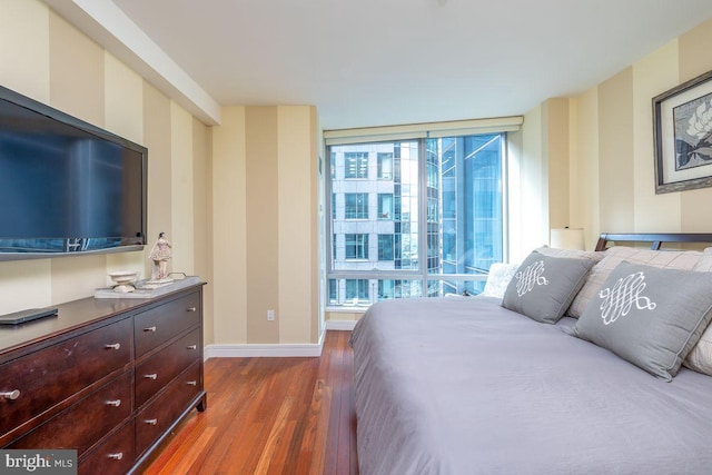 1414 S Penn Sq Unit 18H, Philadelphia, PA 19102 - bedroom with wood finished floors, baseboards, and floor to ceiling windows