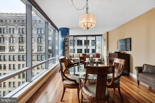 1414 S Penn Sq Unit 18H, Philadelphia, PA 19102 - dining room with hardwood / wood-style flooring, expansive windows, a chandelier, and baseboards