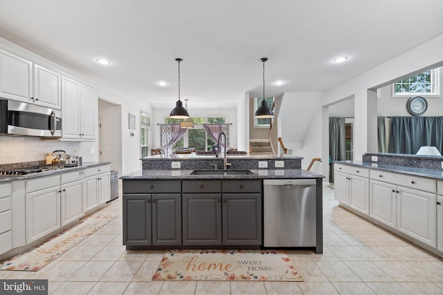 18309 Eldorado Way, Leesburg, VA 20176 - kitchen with stainless steel appliances, a sink, white cabinetry, light tile patterned floors, and recessed lighting