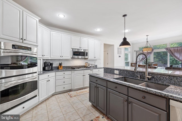 18309 Eldorado Way, Leesburg, VA 20176 - kitchen with appliances with stainless steel finishes, gray cabinets, a sink, white cabinetry, and decorative backsplash