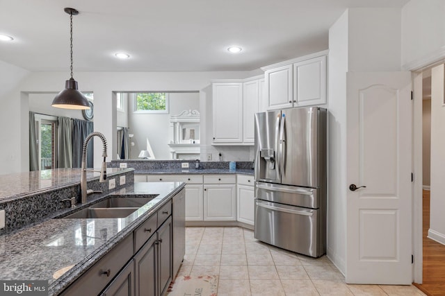 18309 Eldorado Way, Leesburg, VA 20176 - kitchen featuring stainless steel appliances, a sink, white cabinetry, hanging light fixtures, and dark stone countertops