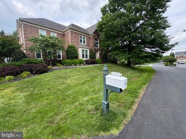 18309 Eldorado Way, Leesburg, VA 20176 - georgian-style home featuring brick siding and a front yard