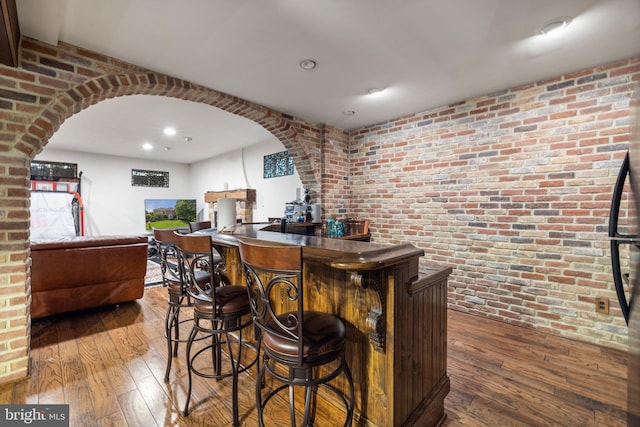 18309 Eldorado Way, Leesburg, VA 20176 - indoor dry bar featuring brick wall, arched walkways, hardwood / wood-style floors, and recessed lighting