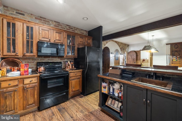 18309 Eldorado Way, Leesburg, VA 20176 - kitchen featuring black appliances, a sink, arched walkways, brown cabinets, and light wood-style floors