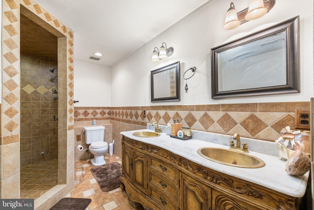 18309 Eldorado Way, Leesburg, VA 20176 - full bathroom with double vanity, toilet, a tile shower, tile walls, and wainscoting