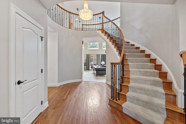 18309 Eldorado Way, Leesburg, VA 20176 - foyer entrance featuring stairway, a high ceiling, baseboards, wood finished floors, and a chandelier