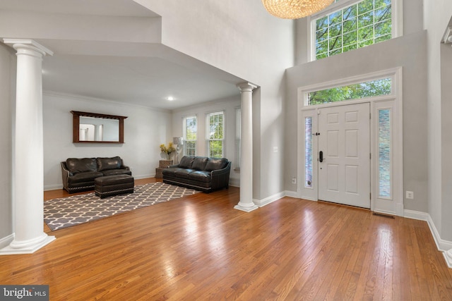 18309 Eldorado Way, Leesburg, VA 20176 - foyer featuring decorative columns, hardwood / wood-style floors, baseboards, a high ceiling, and ornamental molding
