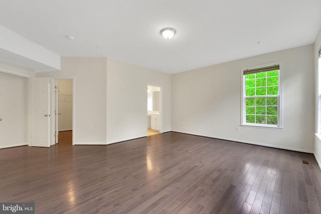 unfurnished room featuring wood finished floors and baseboards