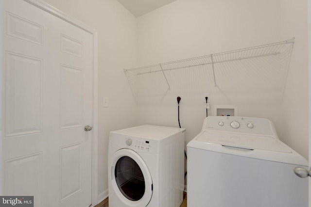 laundry area featuring washing machine and clothes dryer