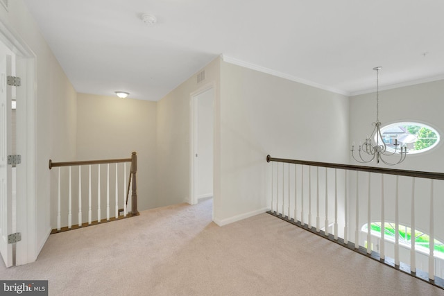 hallway with a chandelier, an upstairs landing, carpet, ornamental molding, and baseboards