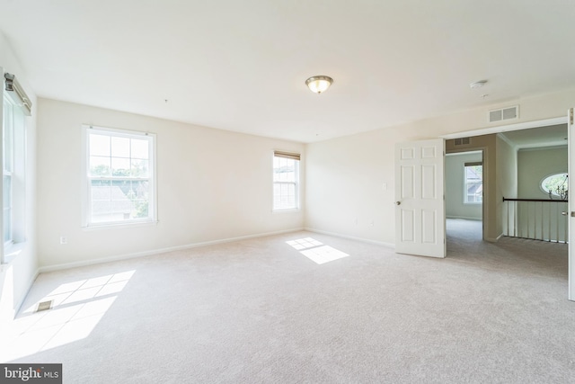 unfurnished room with carpet floors, baseboards, and a smoke detector
