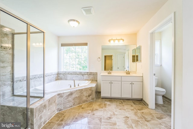 bathroom featuring a garden tub, toilet, vanity, and a shower stall