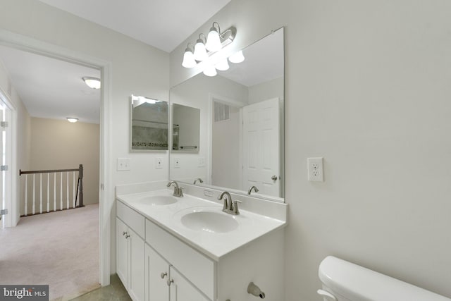full bathroom featuring toilet and double vanity