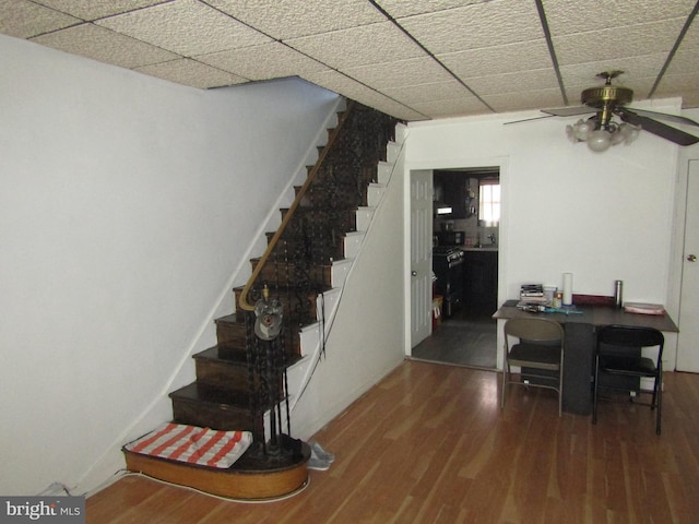 dining area with stairway, wood finished floors, and a ceiling fan
