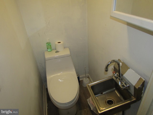 half bath featuring toilet and a sink