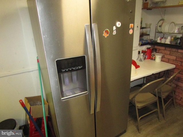 kitchen featuring stainless steel refrigerator with ice dispenser and wood finished floors
