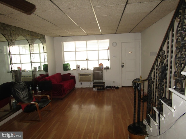 living room featuring wood finished floors and an AC wall unit