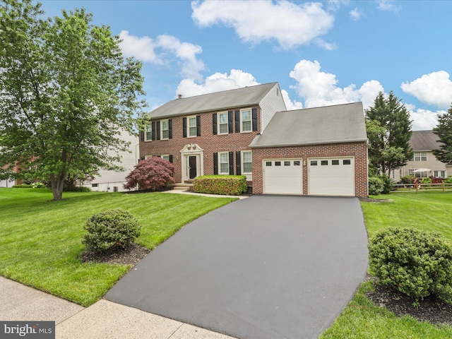 9365 River Crest Rd, Manassas, VA 20110 - colonial inspired home featuring a garage, driveway, brick siding, and a front yard