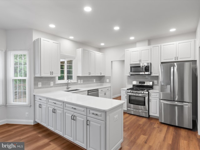 9365 River Crest Rd, Manassas, VA 20110 - kitchen featuring stainless steel appliances, a sink, dark wood-style floors, light countertops, and recessed lighting