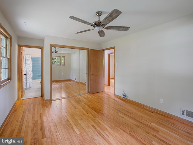 304 Mangrove Rd, Severna Park, MD 21146 - unfurnished bedroom with multiple windows, light wood finished floors, baseboards, and a ceiling fan