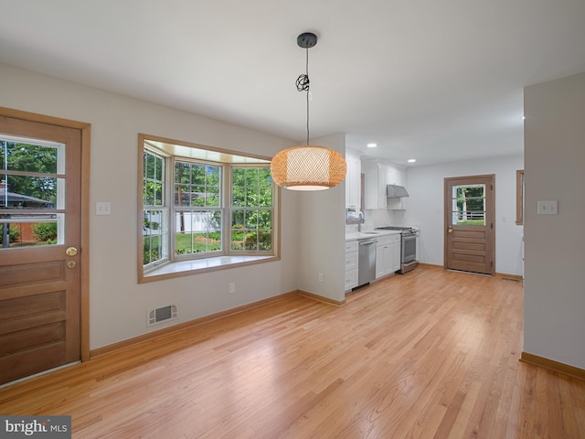 304 Mangrove Rd, Severna Park, MD 21146 - kitchen with stainless steel appliances, white cabinets, light wood-type flooring, baseboards, and light countertops