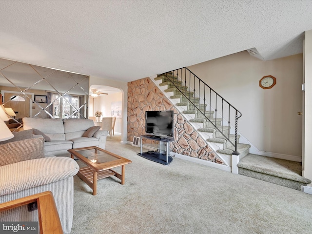 146 Academy Rd, Clifton Heights, PA 19018 - living area featuring stairs, carpet floors, a textured ceiling, baseboards, and arched walkways