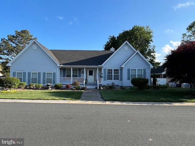 10127 Godspeed Dr, Ocean City, MD 21842 - ranch-style home featuring covered porch, a chimney, a front lawn, and a shingled roof