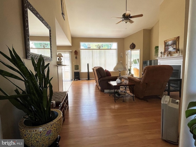 10127 Godspeed Dr, Ocean City, MD 21842 - living room featuring wood finished floors, lofted ceiling, healthy amount of natural light, ceiling fan, and a fireplace