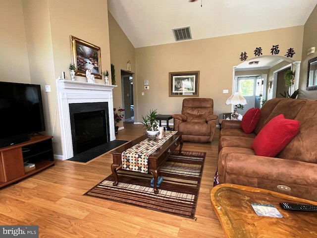 10127 Godspeed Dr, Ocean City, MD 21842 - living area with wood finished floors, a fireplace with flush hearth, high vaulted ceiling, and ceiling fan