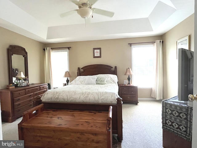 10127 Godspeed Dr, Ocean City, MD 21842 - bedroom with a raised ceiling, light colored carpet, and a ceiling fan