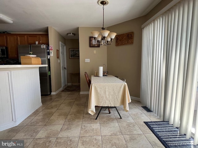 10127 Godspeed Dr, Ocean City, MD 21842 - dining area featuring a chandelier and light tile patterned floors
