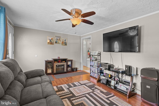 9505 Oakridge Ct, Newburg, MD 20664 - living area with wood finished floors, ceiling fan, a textured ceiling, and ornamental molding