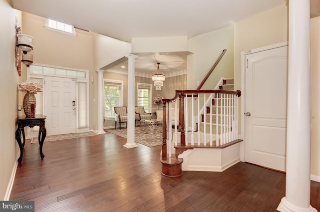 23166 Glenorchy Ct, Ashburn, VA 20148 - foyer entrance with ornate columns, dark wood-type flooring, stairway, and baseboards