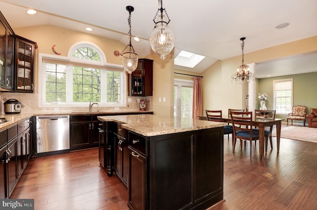 23166 Glenorchy Ct, Ashburn, VA 20148 - kitchen with stainless steel dishwasher, vaulted ceiling, a chandelier, healthy amount of natural light, and a skylight