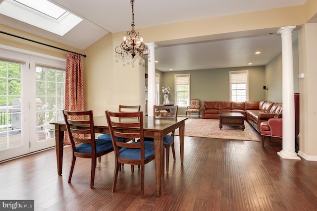 23166 Glenorchy Ct, Ashburn, VA 20148 - dining space featuring dark wood-style floors, vaulted ceiling, decorative columns, a skylight, and recessed lighting