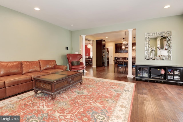 23166 Glenorchy Ct, Ashburn, VA 20148 - living room featuring decorative columns, wood finished floors, recessed lighting, and a chandelier