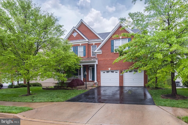 23166 Glenorchy Ct, Ashburn, VA 20148 - view of front of home featuring driveway, an attached garage, a front yard, brick siding, and covered porch