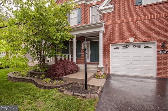 23166 Glenorchy Ct, Ashburn, VA 20148 - doorway to property with brick siding, a porch, driveway, and a garage
