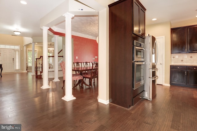 23166 Glenorchy Ct, Ashburn, VA 20148 - kitchen featuring stainless steel appliances, decorative columns, dark brown cabinets, decorative backsplash, and dark wood-type flooring