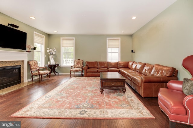 23166 Glenorchy Ct, Ashburn, VA 20148 - living area featuring healthy amount of natural light, wood finished floors, a high end fireplace, recessed lighting, and baseboards