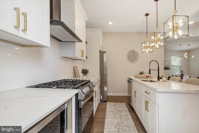 kitchen featuring a sink, stainless steel appliances, decorative backsplash, a chandelier, and recessed lighting