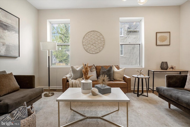 living area featuring baseboards